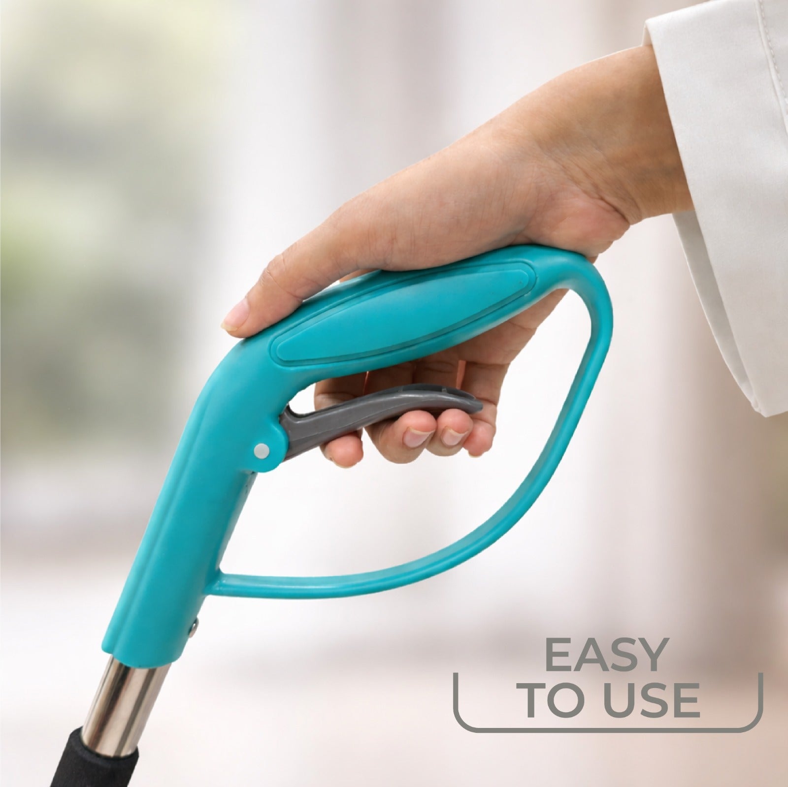 Zidello flip spray mop with stainless steel handle and chenille microfiber mop refill, spraying water while cleaning a tiled kitchen floor for efficient home floor cleaning.
